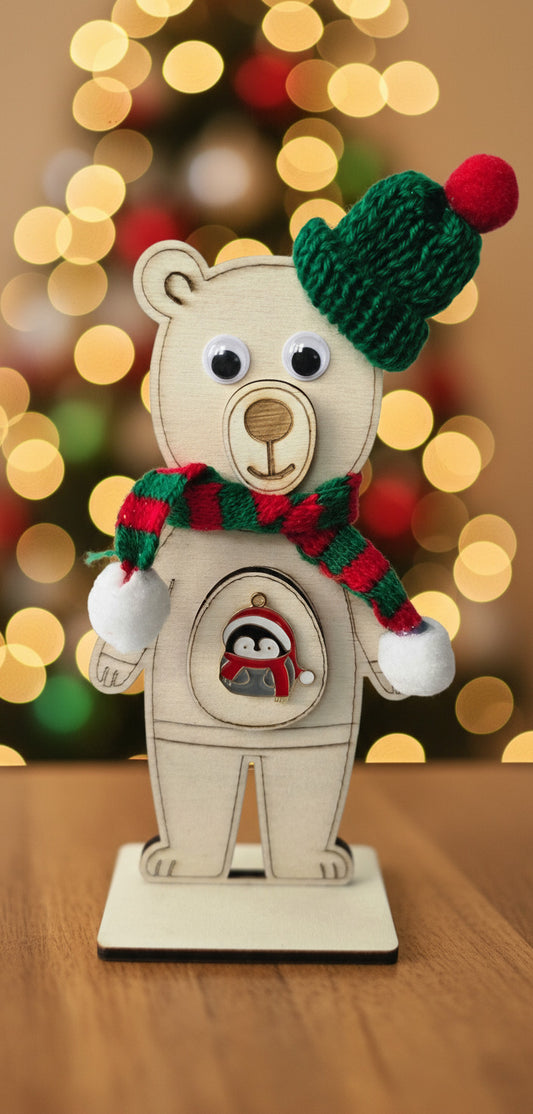 Cute wooden polar bear decoration with a green hat and red scarf on a white background